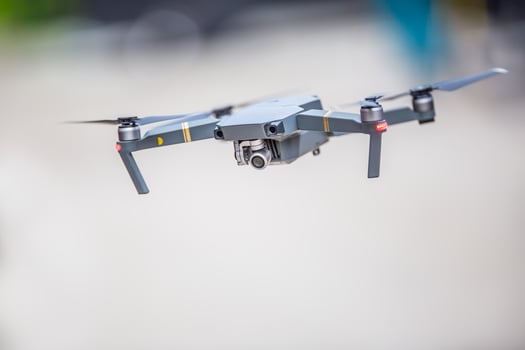 Close-up quadcopter drone with camera flying in park photo