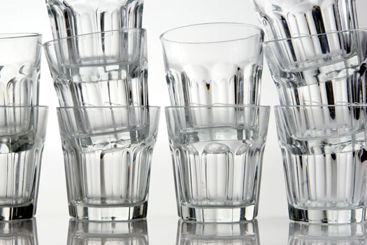 a stack of empty glasses on a table photo