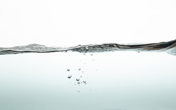 water wave with bubbles on white background. Water splash isolated on the white background. photo
