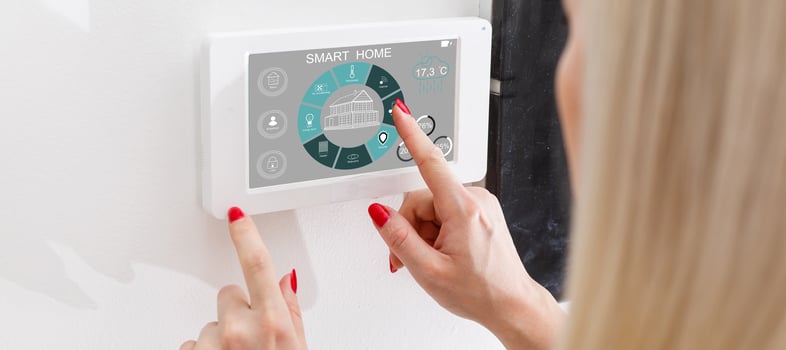 Woman use application for smart home control on tablet. Interior of living room in the background. photo
