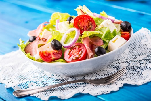 Salad. Fresh summer lettuce salad.Healthy mediterranean salad olives tomatoes parmesan cheese and prosciutto photo
