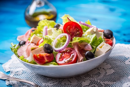 Salad. Fresh summer lettuce salad.Healthy mediterranean salad olives tomatoes parmesan cheese and prosciutto photo