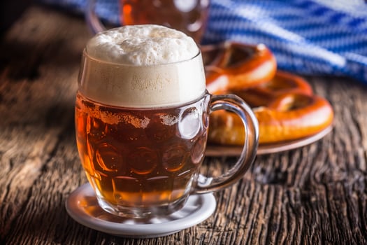 Beer and Oktoberfest. Draft beer pretzel and blue checkered tablecloth as traditional products for bavarian festival oktoberfest photo