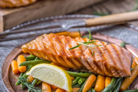 Grilled salmon steak with vegetable and herbs. photo