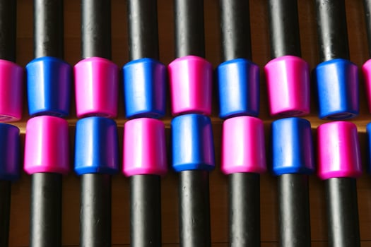 a pile of blue and pink plastic toys on a wooden floor photo
