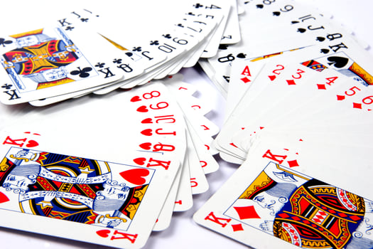 a pile of playing cards on a table photo