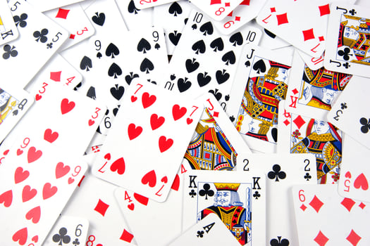 a pile of playing cards on a table photo