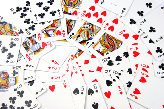 a pile of playing cards on a table photo