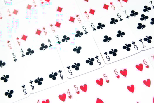 a pile of playing cards on a table photo