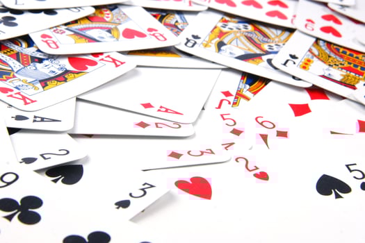 a pile of playing cards on a table photo