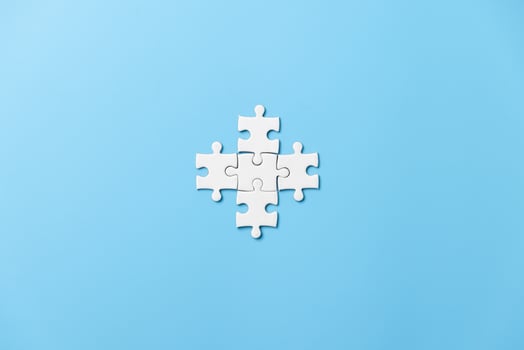 Many white jigsaw puzzle on blue background - idea solution concept. photo