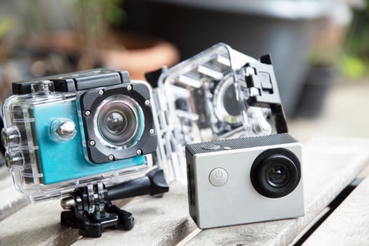 2 action cams placed on the floor, waterproof and dustproof photo