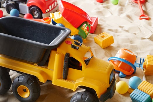 sand and colorful toys in a playground indoors. photo