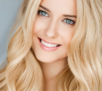 Beautiful blonde woman smiling, white teeth smile photo