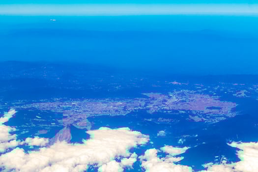 Flying by plane over Mexico view of volcanoes mountains clouds. photo