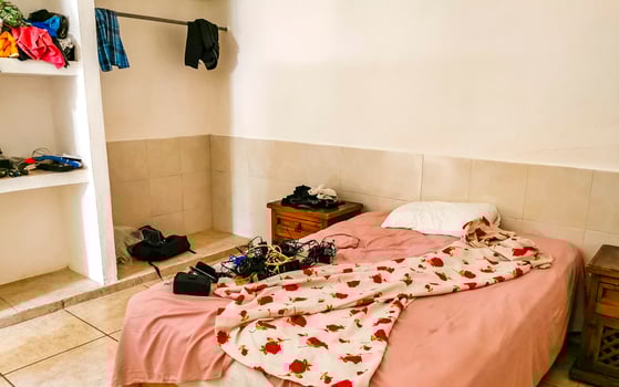 Playa del Carmen Quintana Roo Mexico 2023 Simple small apartment hotel room with bed table in Mexico. photo