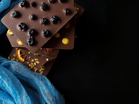 Pieces of chocolate. With berries, strawberries, oranges. photo