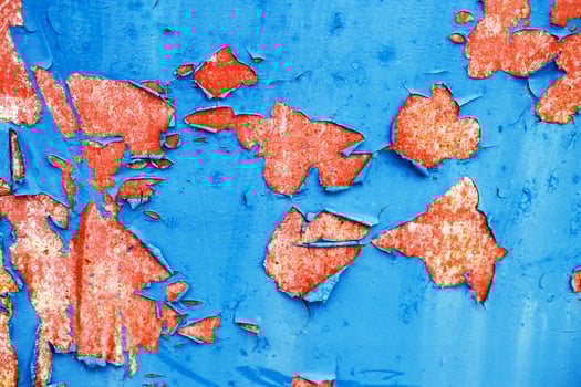 Old blue paint peeling from red concrete wall texture background. photo