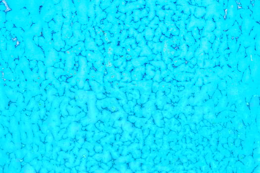 Old blue paint peeling from metal or concrete wall texture background. photo