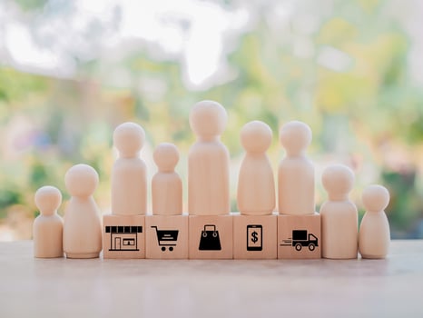 Wooden human figure with money icon and wooden block with online shopping and e-commerce icons set. photo