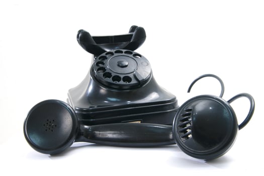 a black telephone on a white background photo