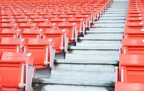 Empty orange seats at stadium,Rows of seat on a soccer stadium photo