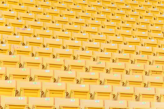 Empty yellow seats at stadium,Rows of seat on a soccer stadium,select focus photo