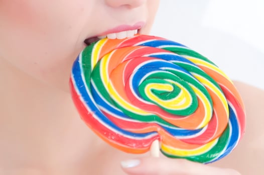 a woman holding a large lollipop photo