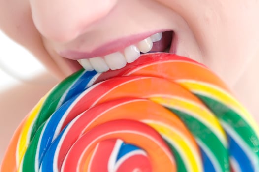 a woman holding a large lollipop photo