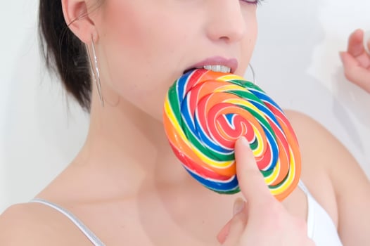 a woman holding a large lollipop photo