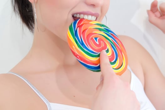 a woman holding a large lollipop photo