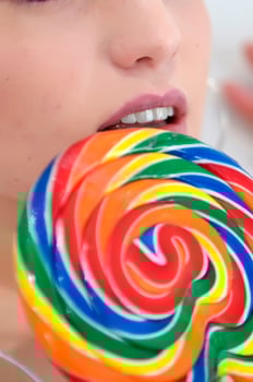 a woman holding a large lollipop photo