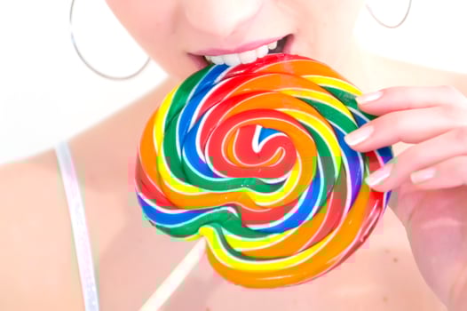 a woman holding a large lollipop photo
