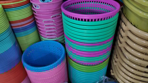 Cheap plastic household items for sale on the market close up photo