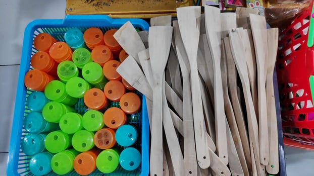 Cheap plastic household items for sale on the market close up photo