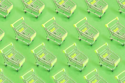Top view of pattern Empty shopping cart on green background, buy and sell concept. photo
