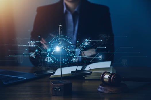 Justice and law concept.Male judge in a courtroom with the gavel, working with, computer and docking keyboard, eyeglasses, on table in morning light photo