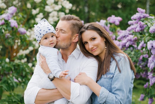 Mom, dad and baby boy walk in the spring in the park A happy young family spends time together, outdoors, on vacation, in the fresh air. The concept of family holidays photo