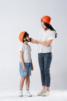mother and son wearing helmets and riding motorbikes photo