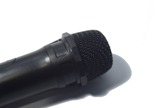 Close up black microphone isolated on white background photo