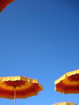 a row of orange and yellow umbrellas photo