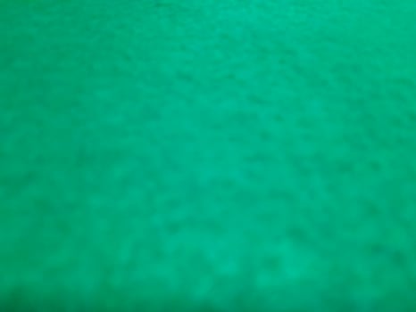 Defocused abstract carpet background in bright Tosca green color photo