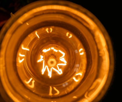 Lamp close view background, light bulb over black background photo