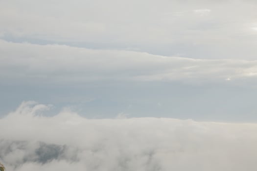 Mountain range with visible silhouettes through the morning blue fog. photo