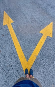 Deciding which way to walk following the signs on the paved road photo