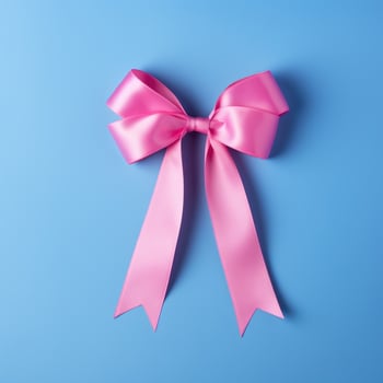 A pink ribbon on a blue background. Breast Cancer Month. photo