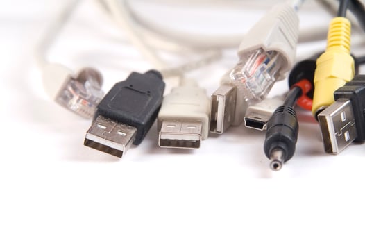 a hand holding several different types of cables photo