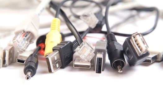 a hand holding several different types of cables photo