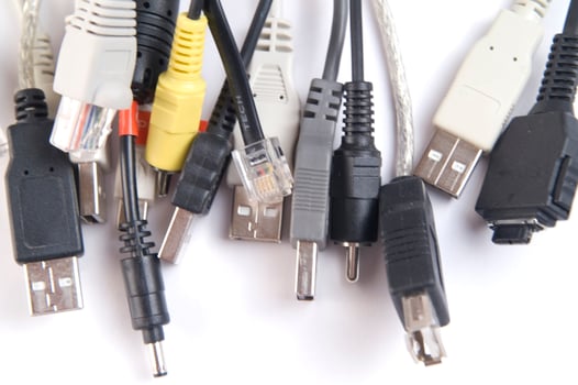 a hand holding several different types of cables photo