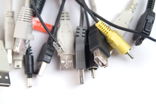 a hand holding several different types of cables photo